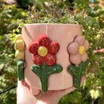 Frisk, glad og solrig urtepotteskjuler som er perfekt til blomster og krydderurter.
