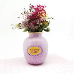 Lille buttet vase i muntert design og med teksten "Enjoy it all" på. Den er i de yndigste farver, som er perfekt til en mindre buket blomster,